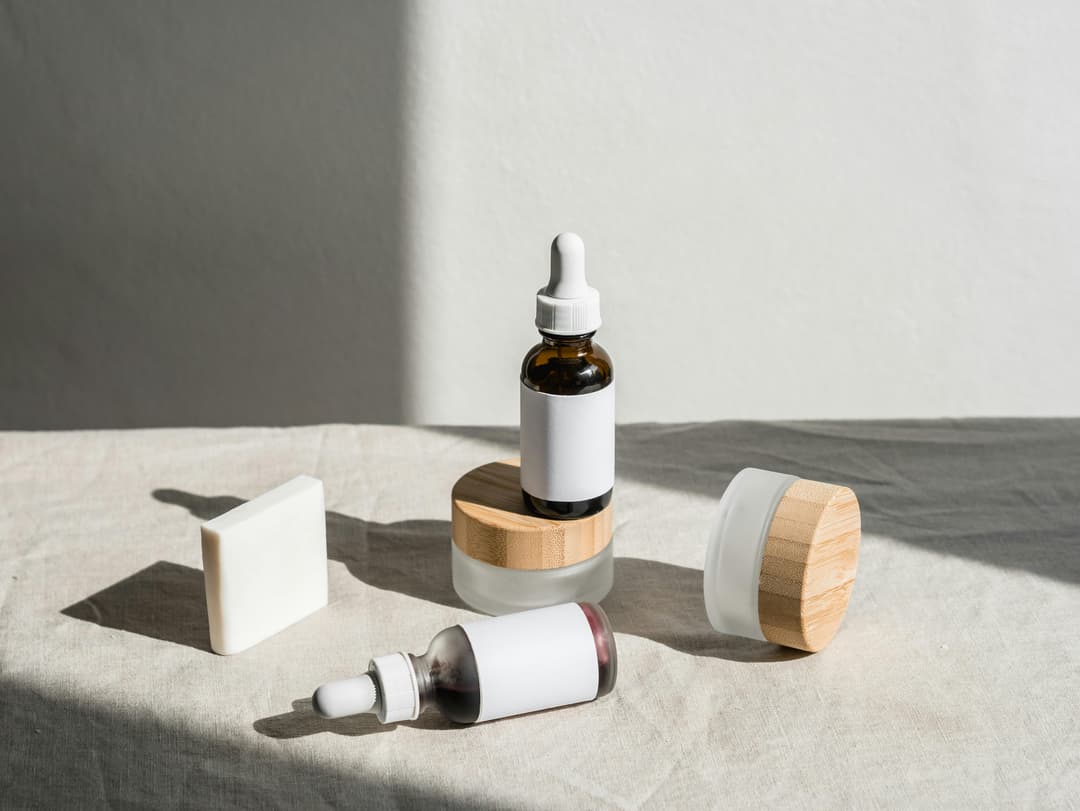 Beauty and cosmetics packaging including dropper bottles, jars with wooden lids